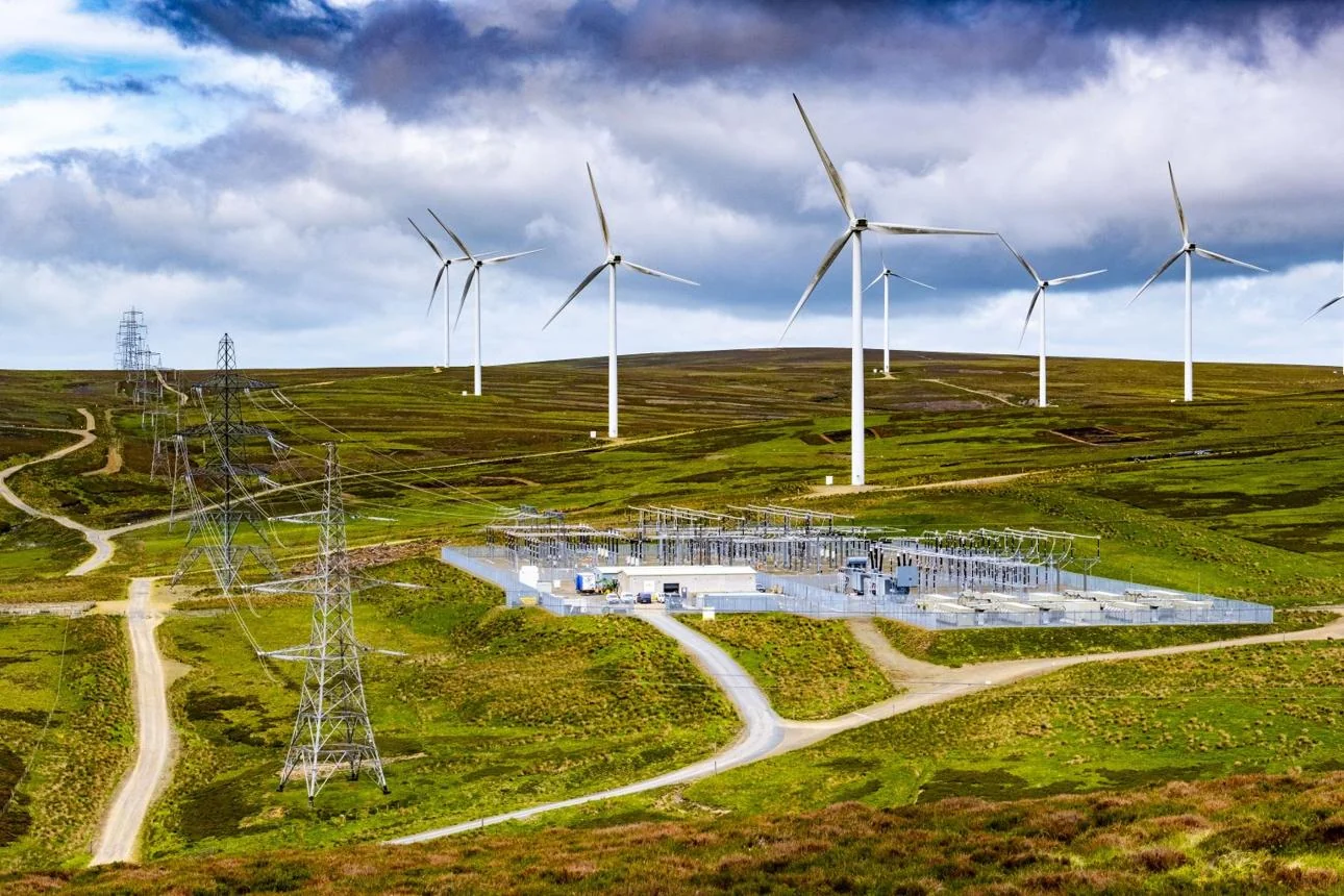 Wind turbines, electricity transmission and a substation in the Scottish landscape